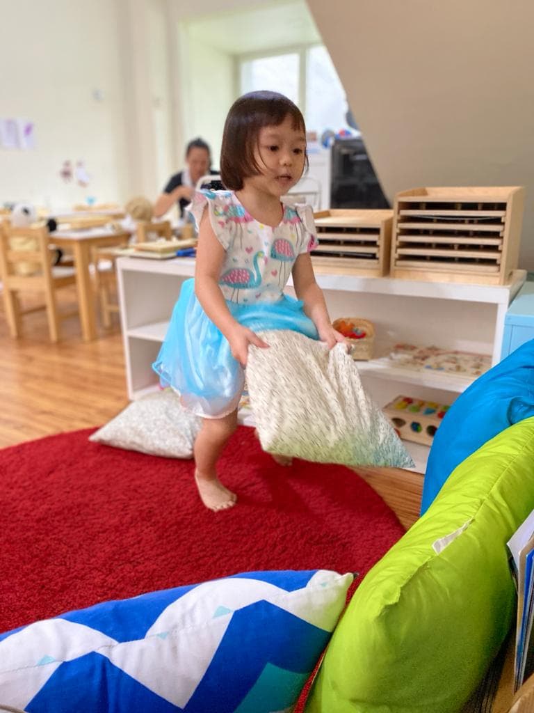 a student playing with pillows